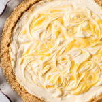 A no bake lemon pie with swirls of lemon curd on top.