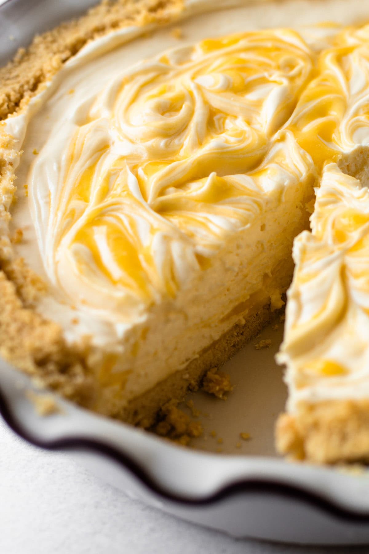 A no bake lemon pie with a slice taken out of it.