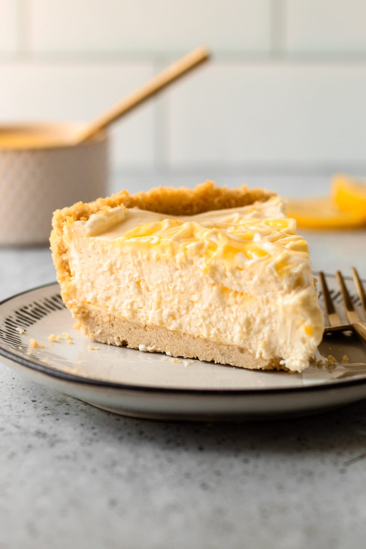 A slice of no bake lemon pie on a plate.