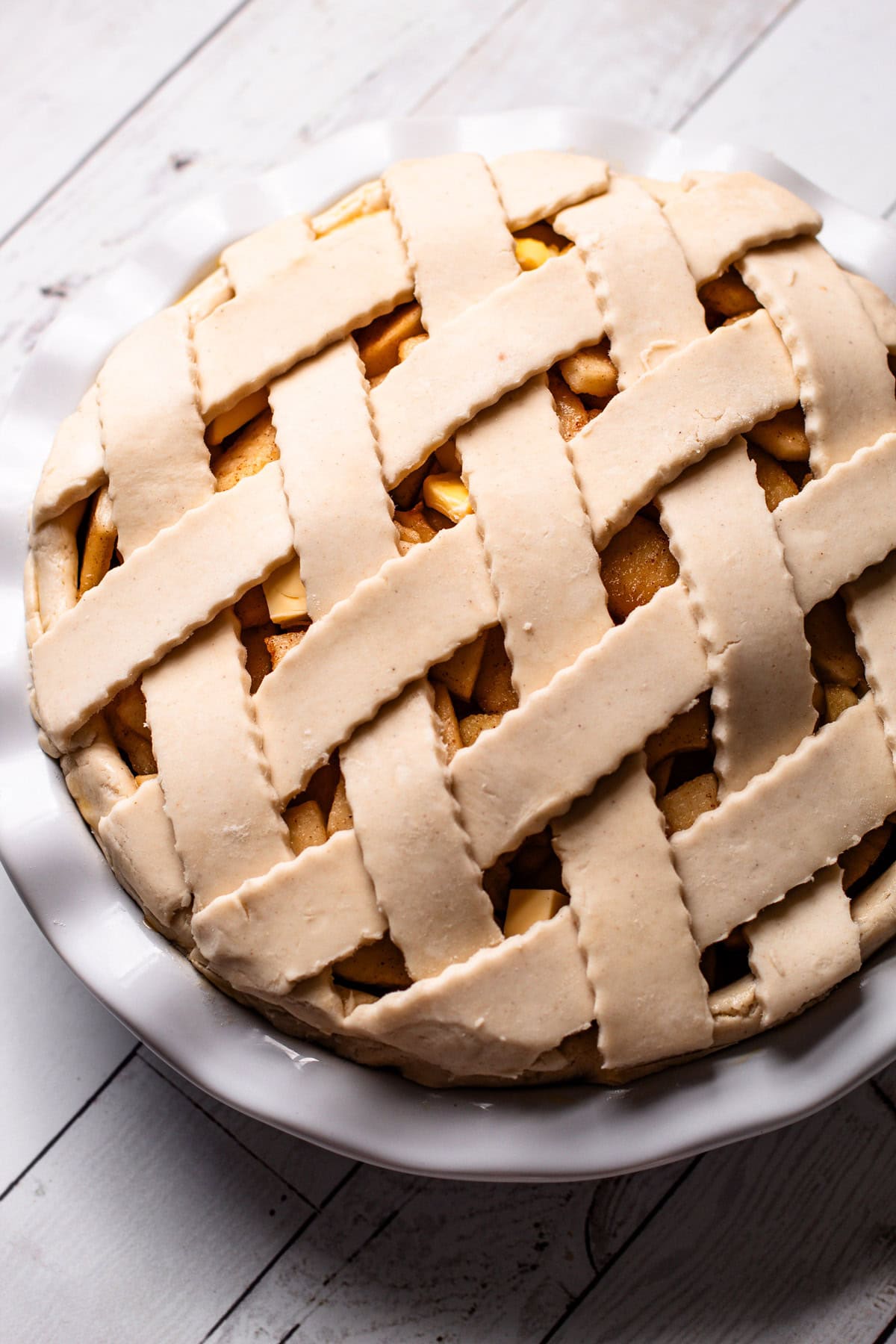 An unbaked gluten free apple pie with a lattice.