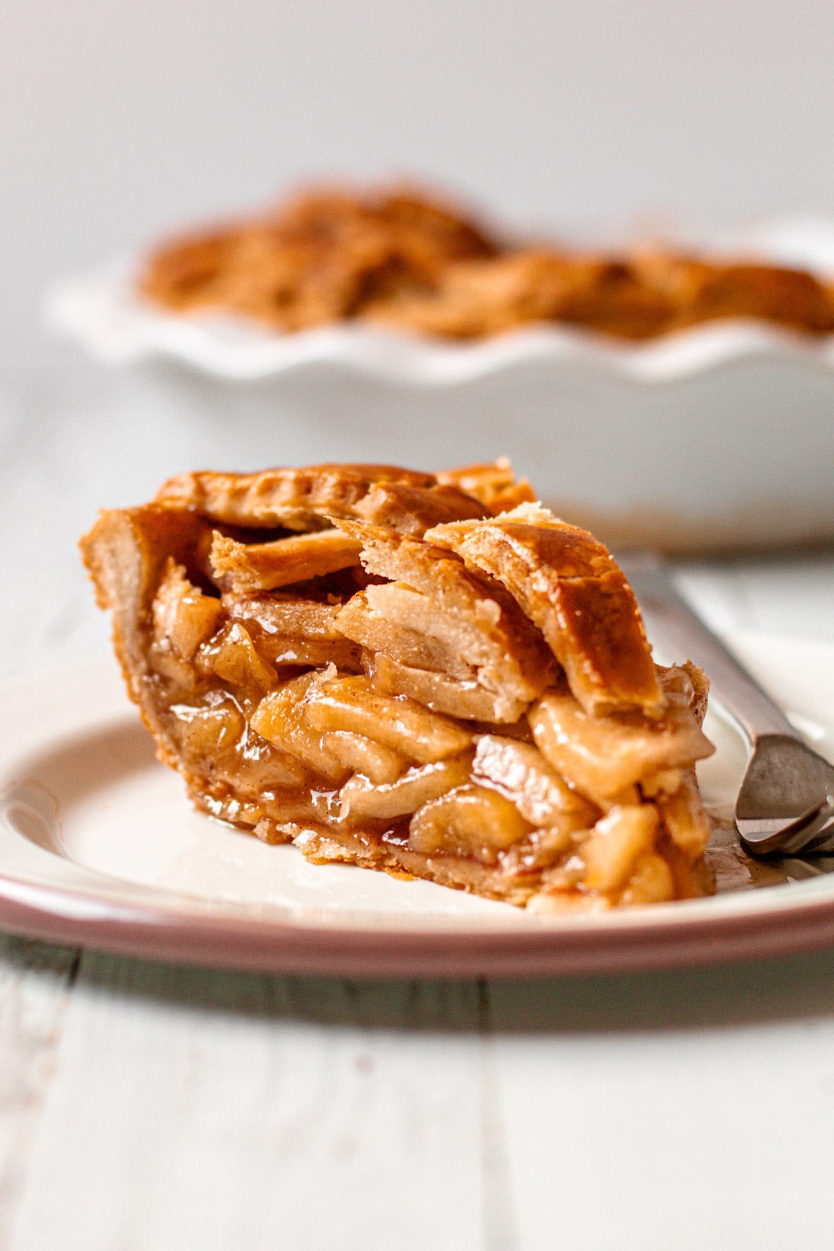 A slice of gluten free apple pie on a plate.