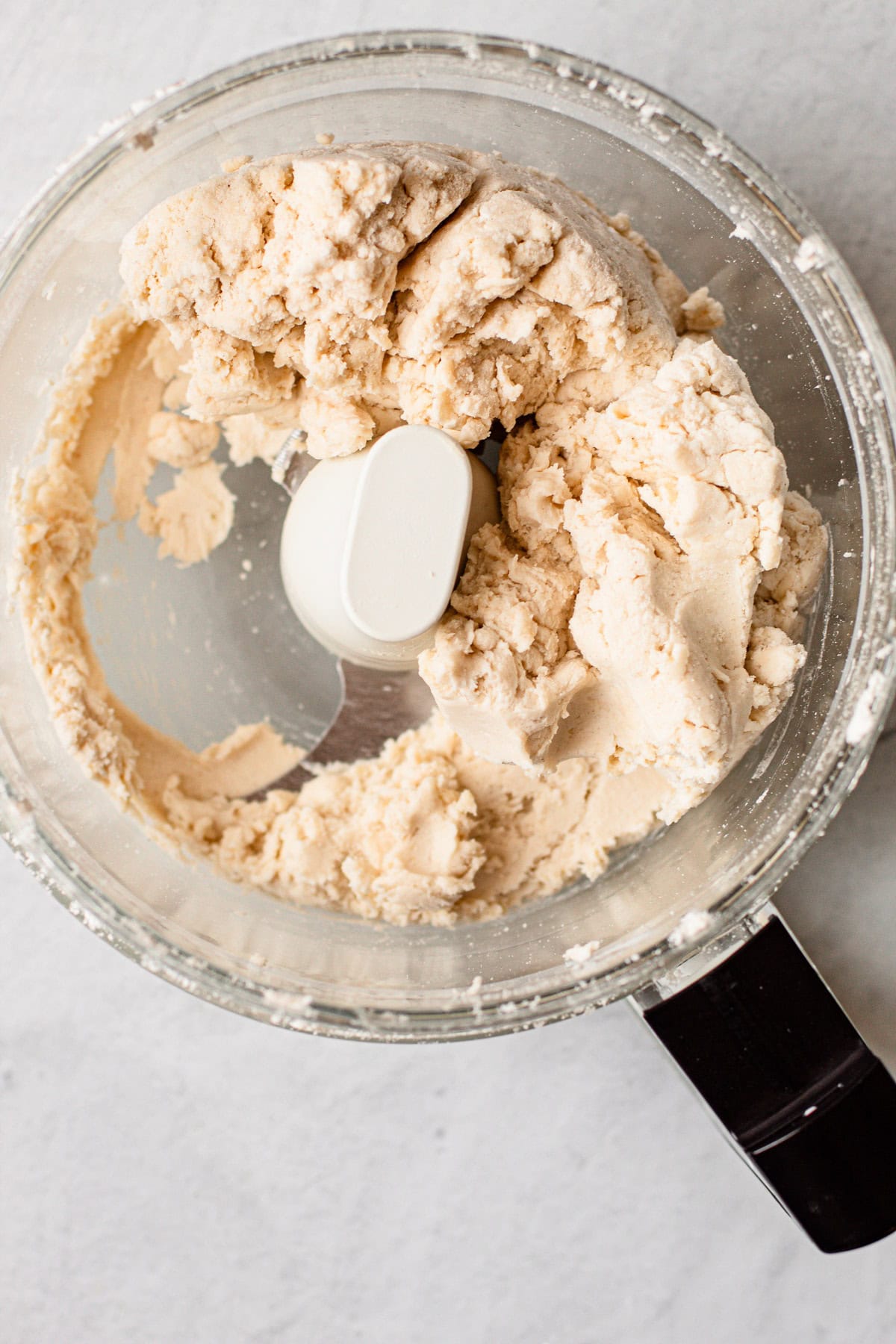 A gluten free pie crust in a food processor.