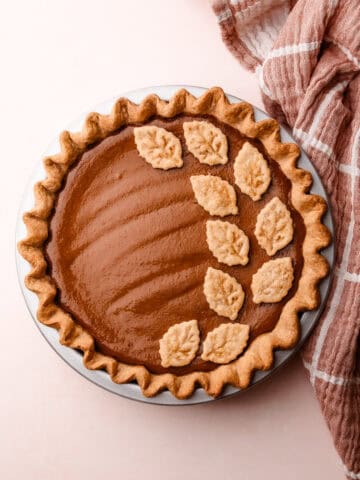 The finished apple butter pie with golden crust details and a warm, autumnal look.