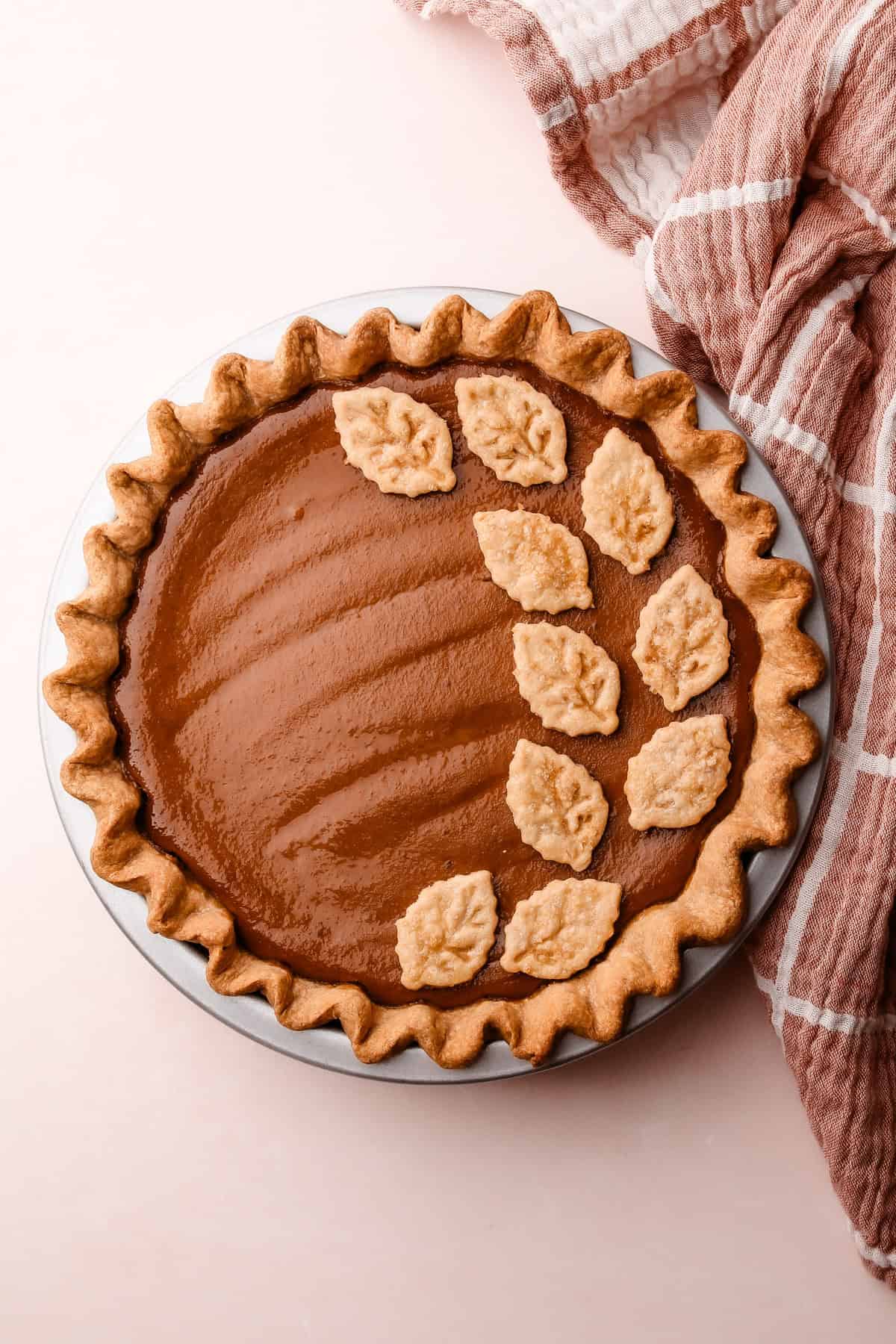 The finished apple butter pie with golden crust details and a warm, autumnal look.