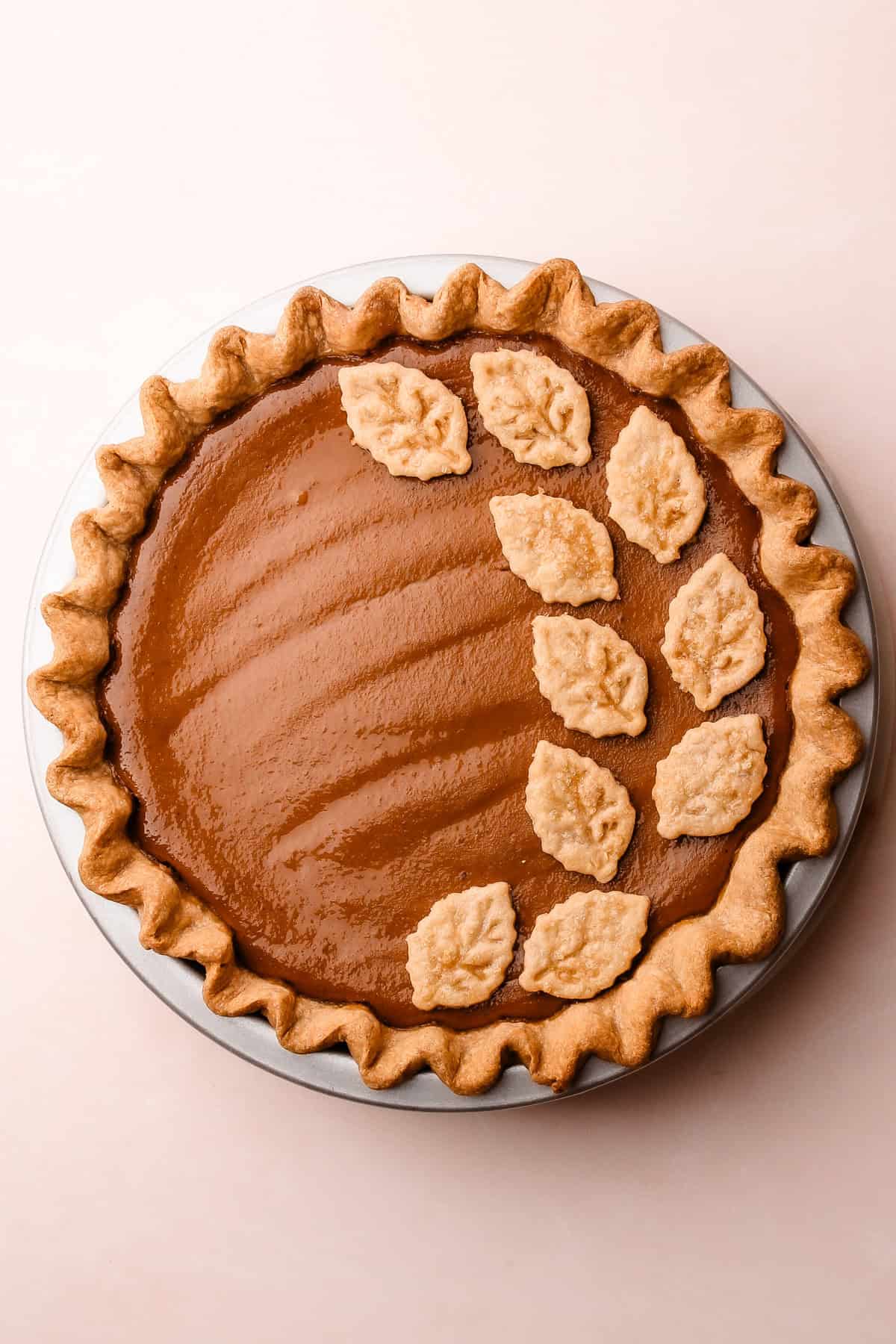 The finished apple butter pie with golden crust details and a warm, autumnal look.