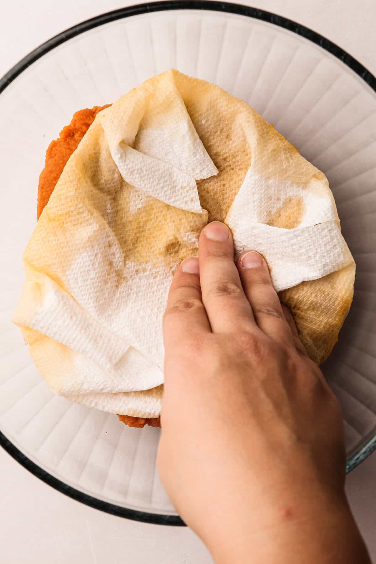 Blotting pumpkin puree for a pumpkin pasty recipe.