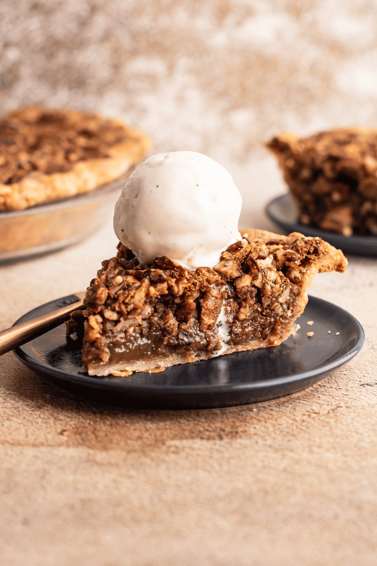 A slice of pecan pie with a scoop of ice cream on top.