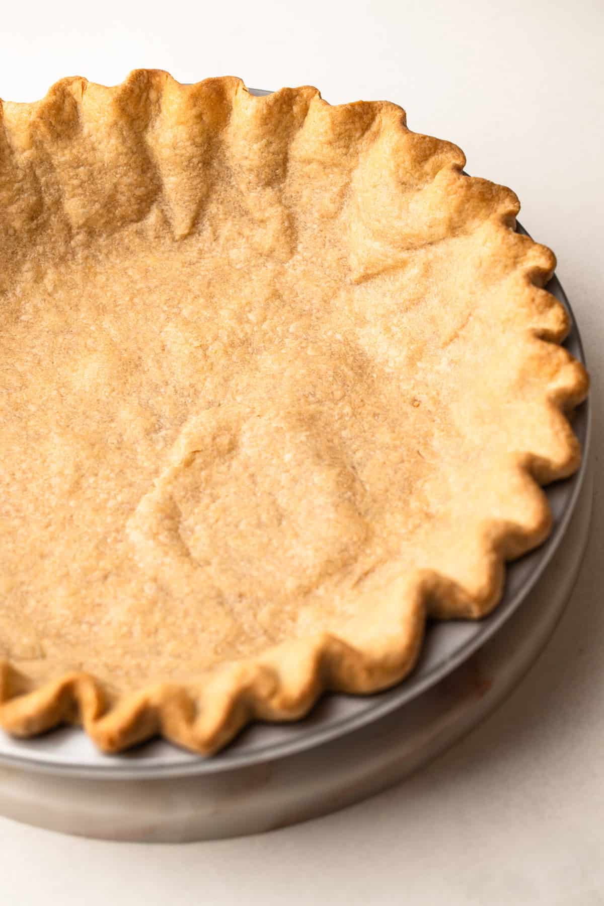 A whole grain pie crust baked in a tin.