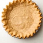 A whole wheat pie crust baked in a tin.