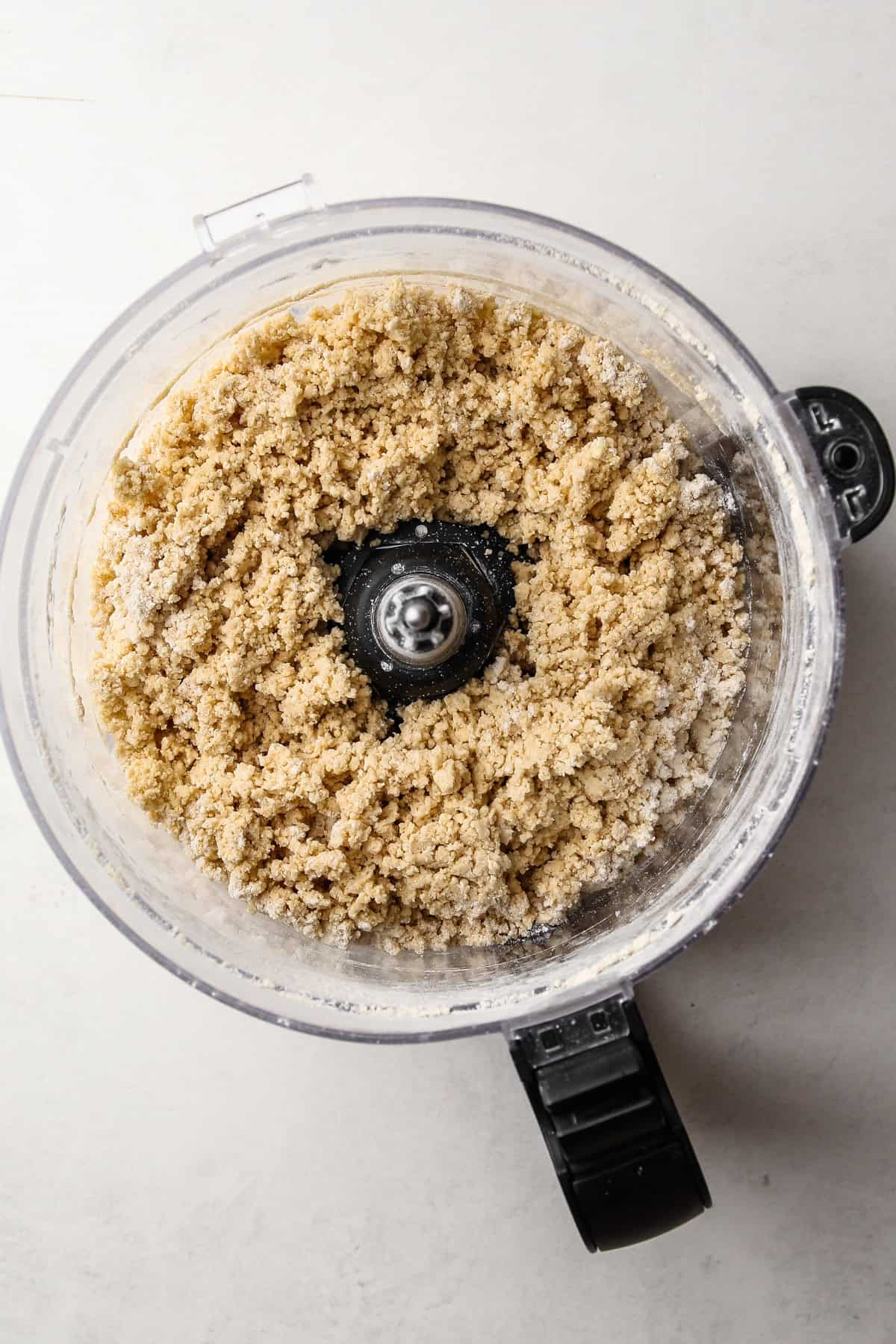 Whole wheat flour pie dough in a food processor.