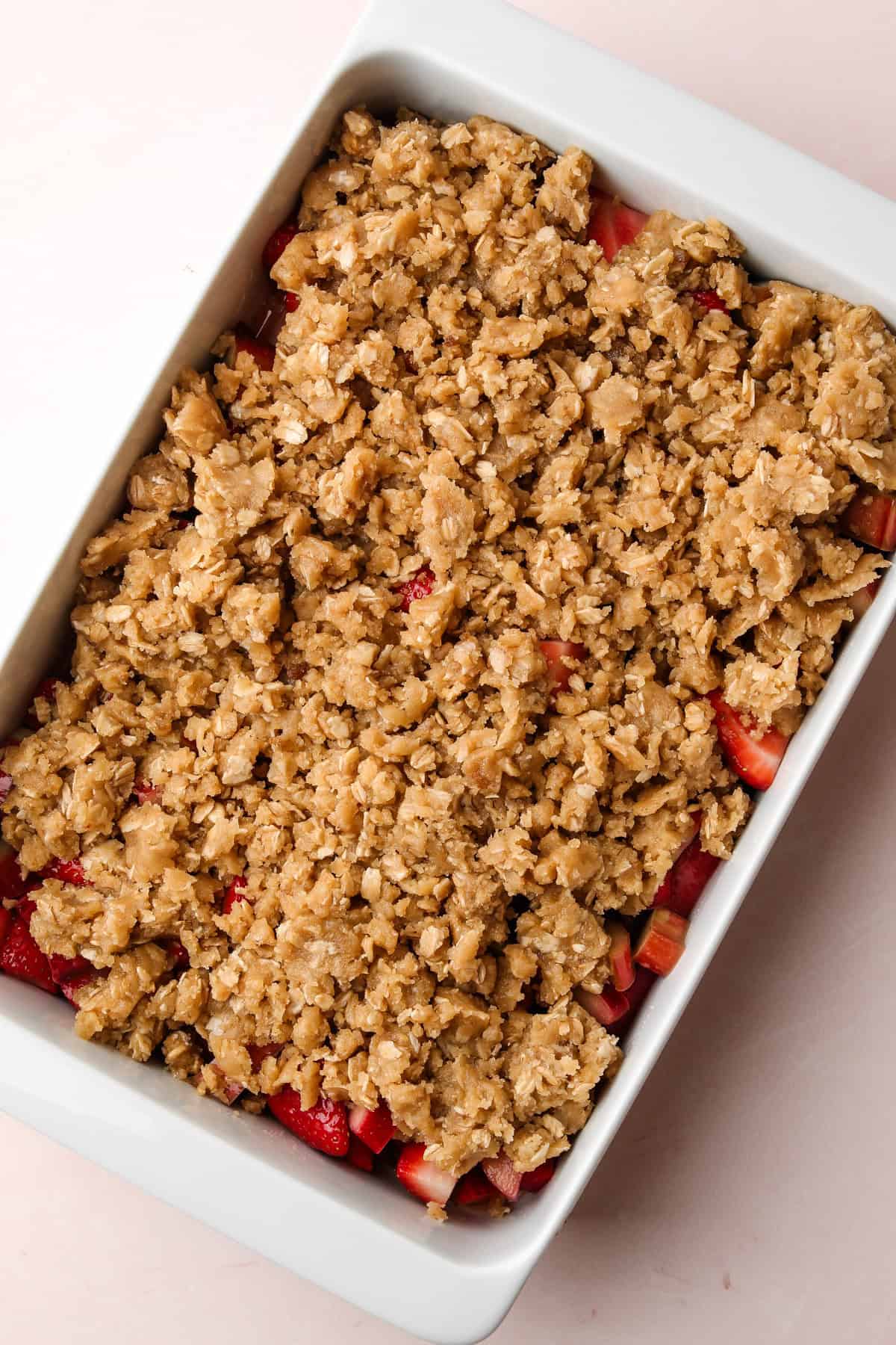 An assembled but unbaked strawberry rhubarb crisp.