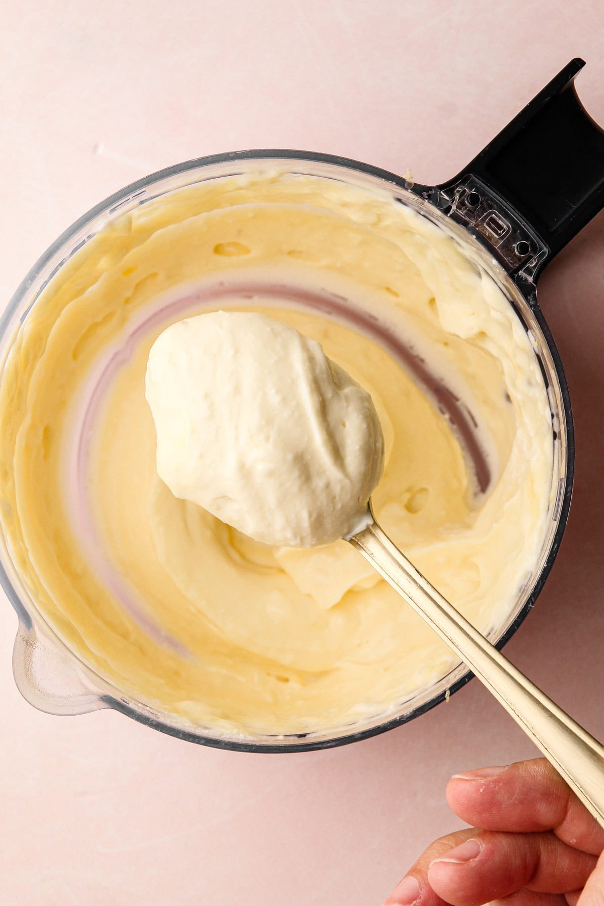 A spoonful of whipped ricotta mixture for the lemon asparagus tart filling.