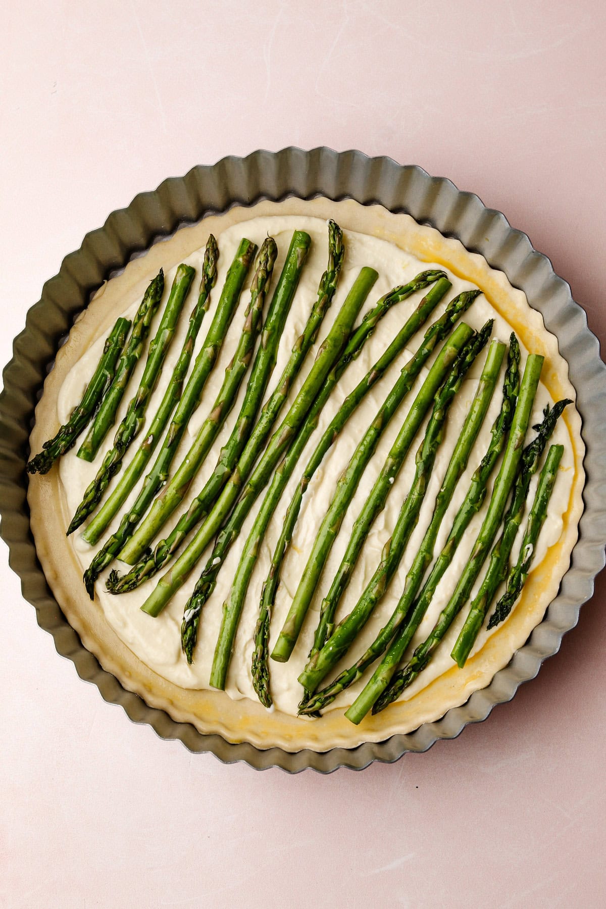 An unbaked lemon ricotta asparagus tart.