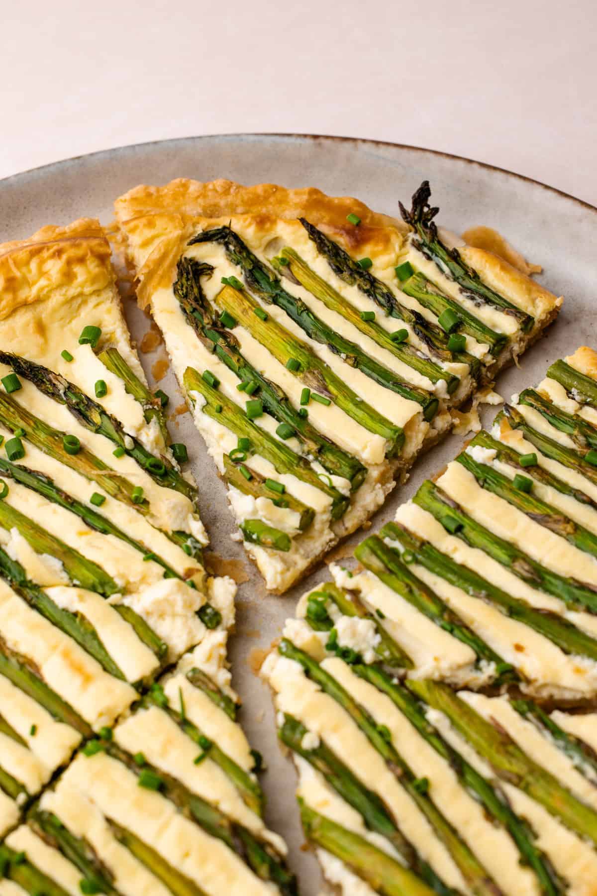 A sliced asparagus tart showing the creamy filling and flaky crust.