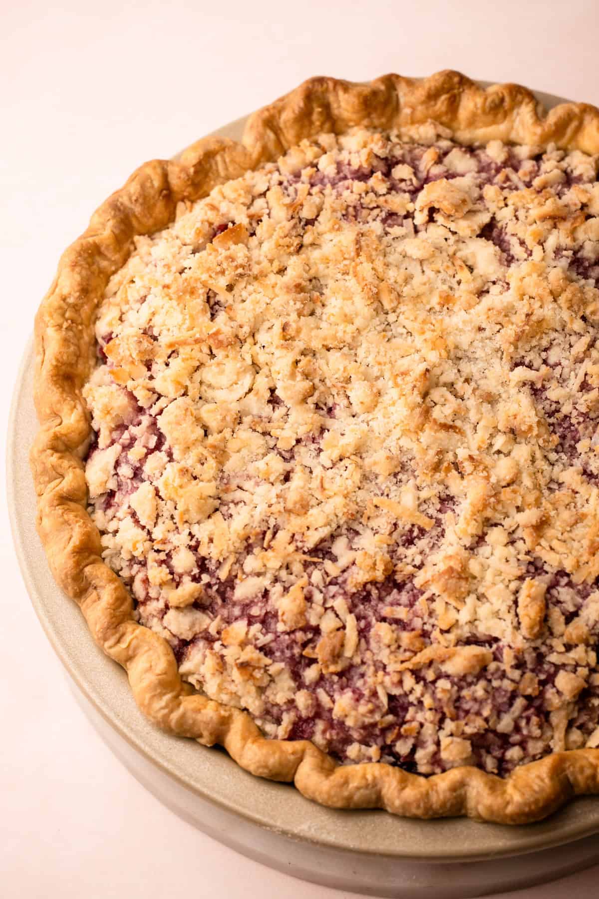 A raspberry pie with a coconut macaroon streusel topping.