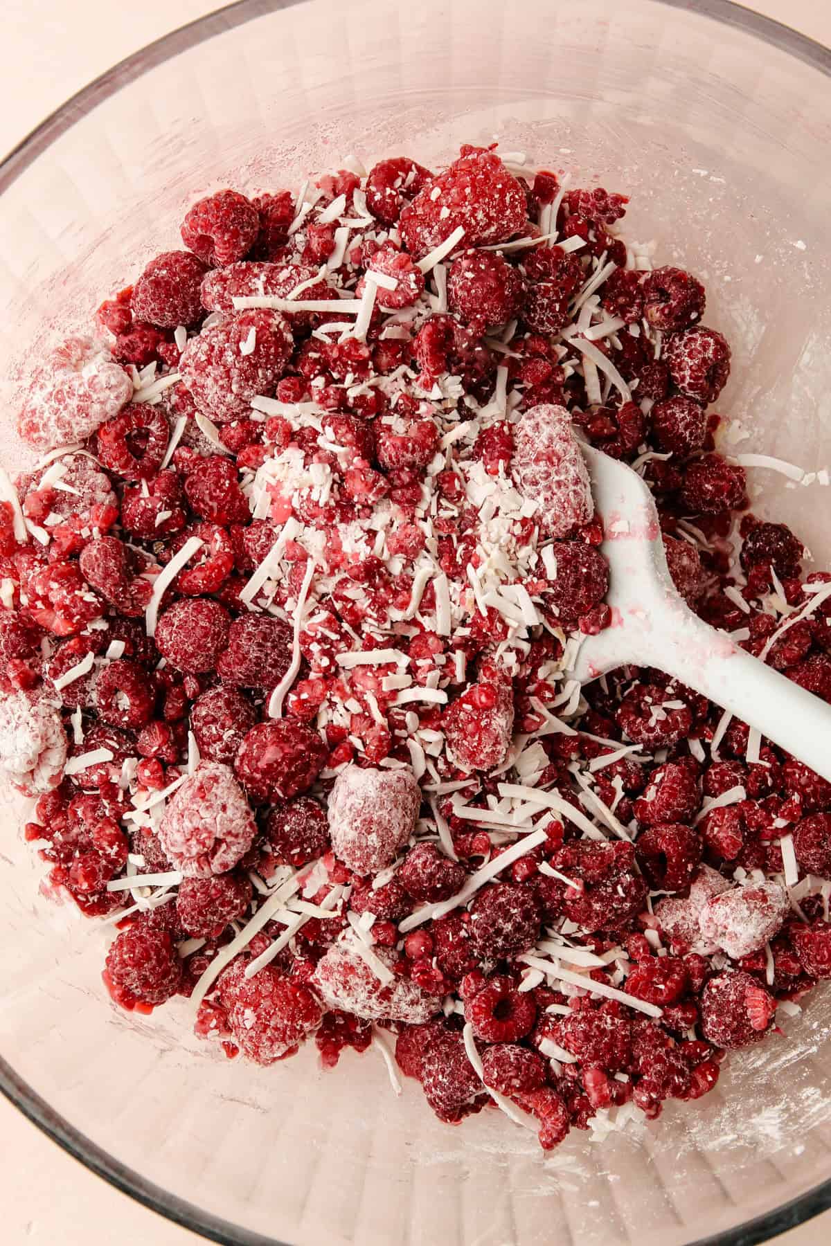 Mixing together a raspberry filling for a pie.