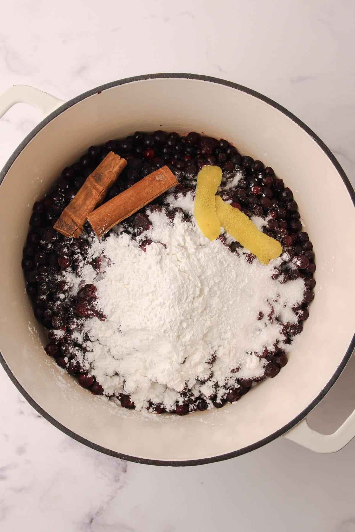 The ingredients for blueberry pie filling in a pot.