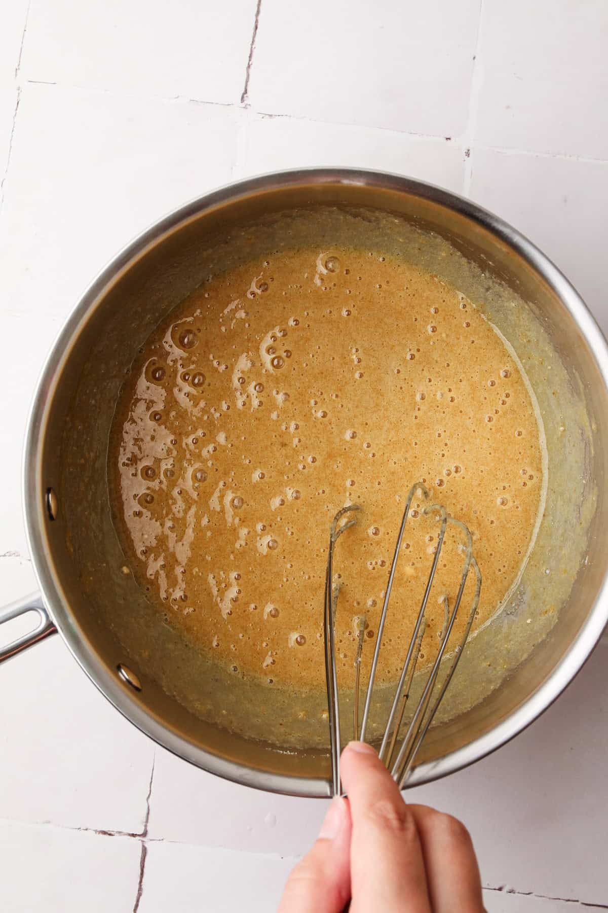 Whisking together the eggs, sugar and milk powder for grapenut ice cream.