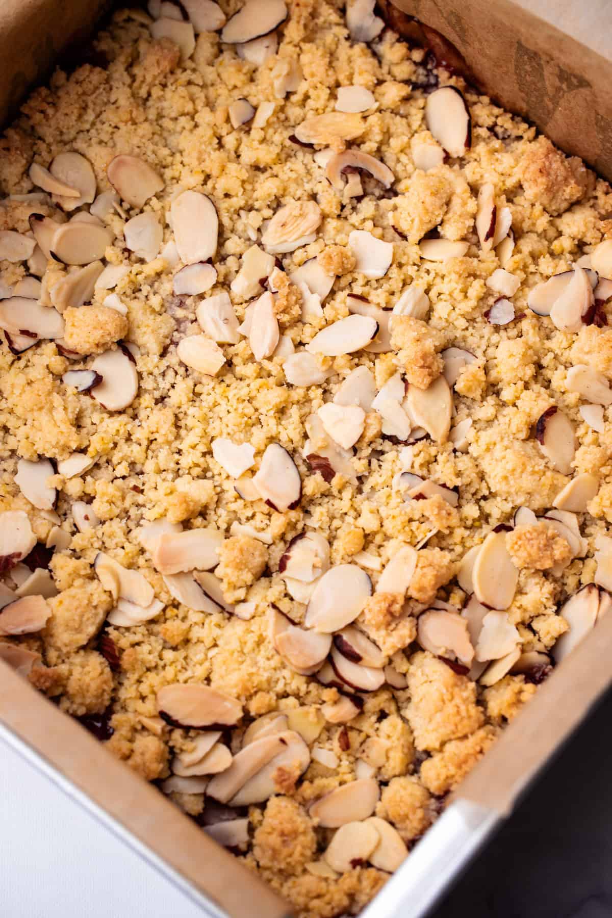 Baked rhubarb almond crumb bars in a baking dish.