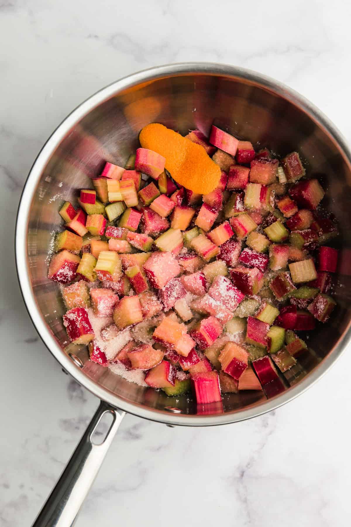 Ingredients to make rhubarb coulis in a pot.