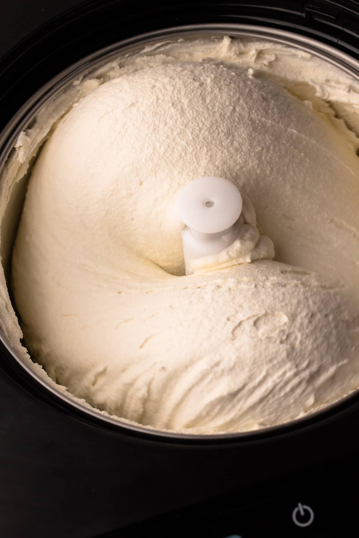 Spinning French Vanilla ice cream in an ice cream machine.