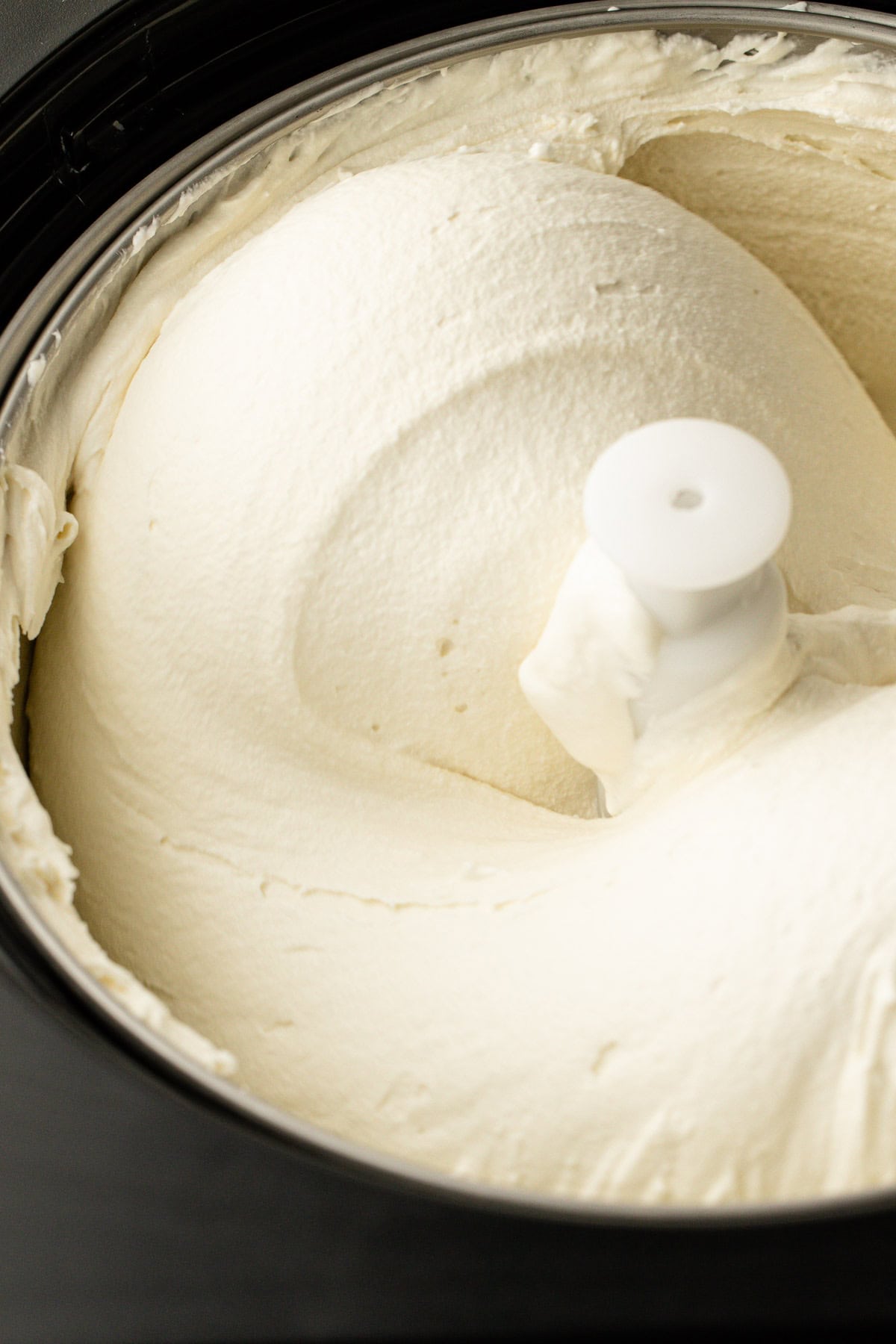 Homemade basil ice cream churning in an ice cream maker.