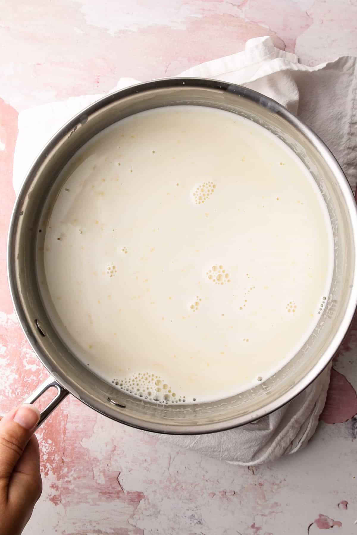 The base for homemade basil ice cream in a pot.