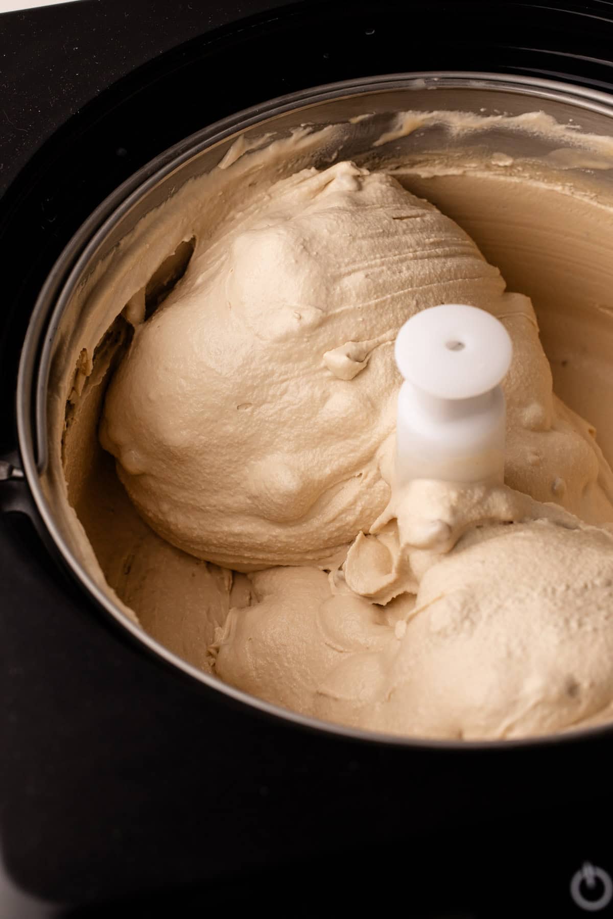Maple walnut ice cream in an ice cream machine.