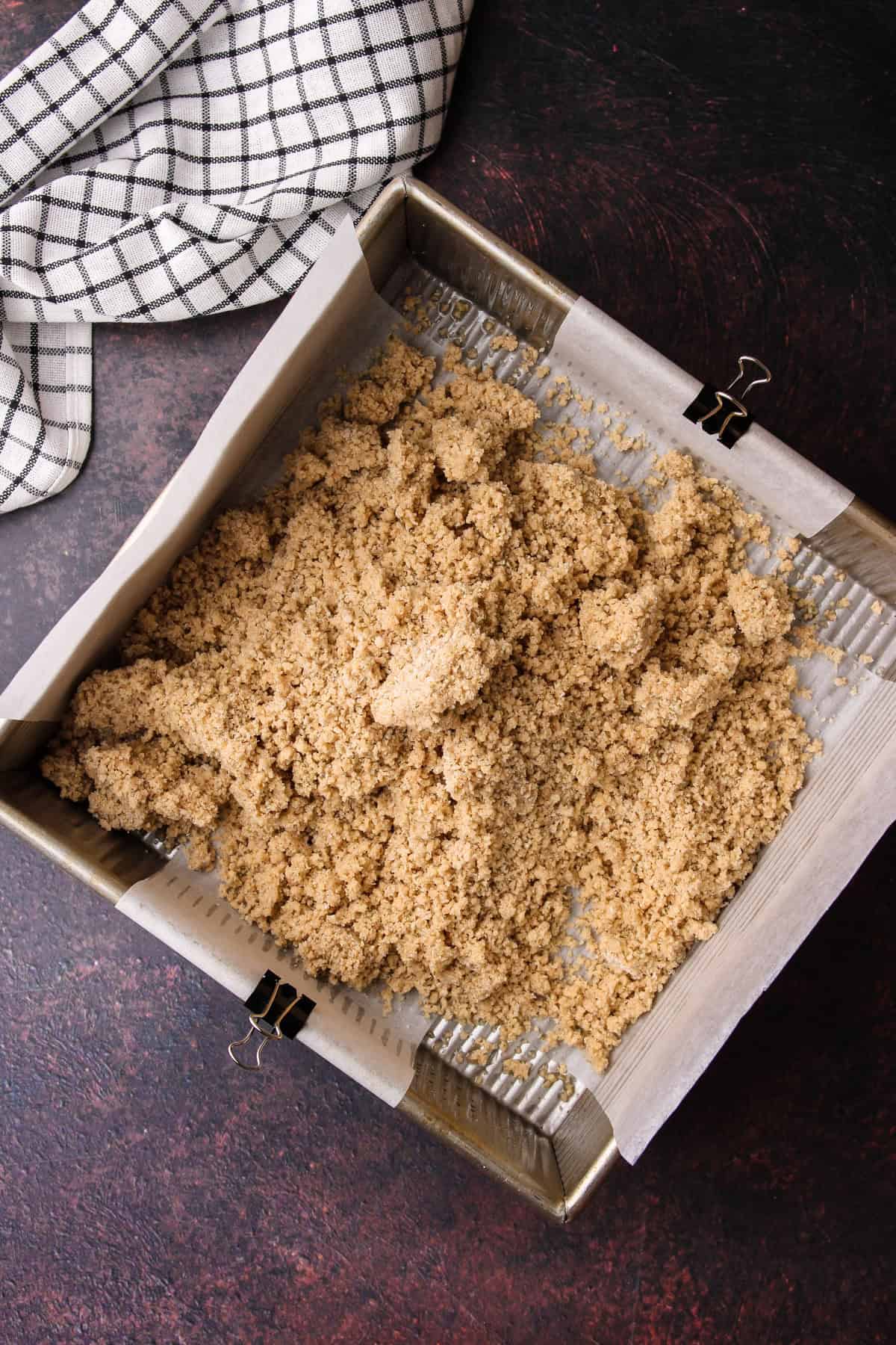 The shortbread crumbs poured into the baking dish.