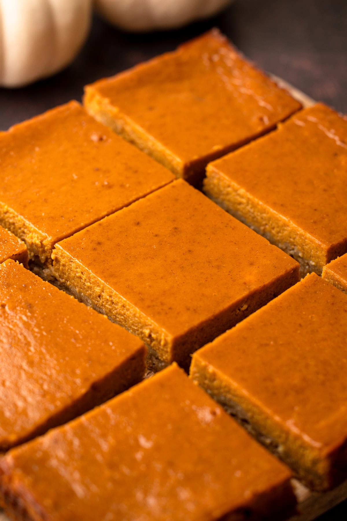 Sliced pumpkin pie bars on a serving tray.