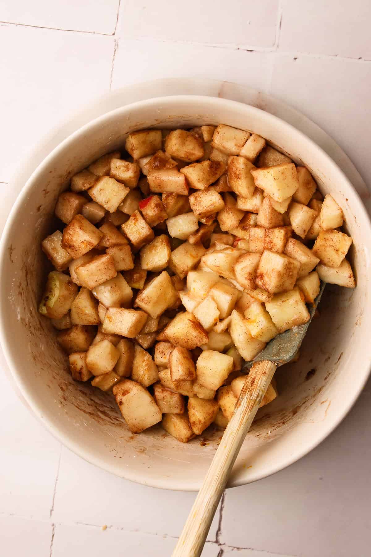 Mixing together the diced apples and blueberries with sugar and spices