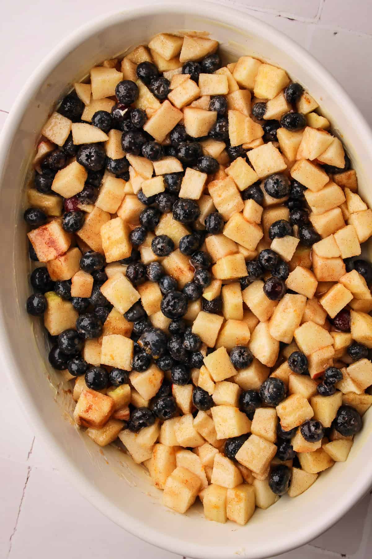 The apple blueberry crisp filling unbaked in the prepared dish.