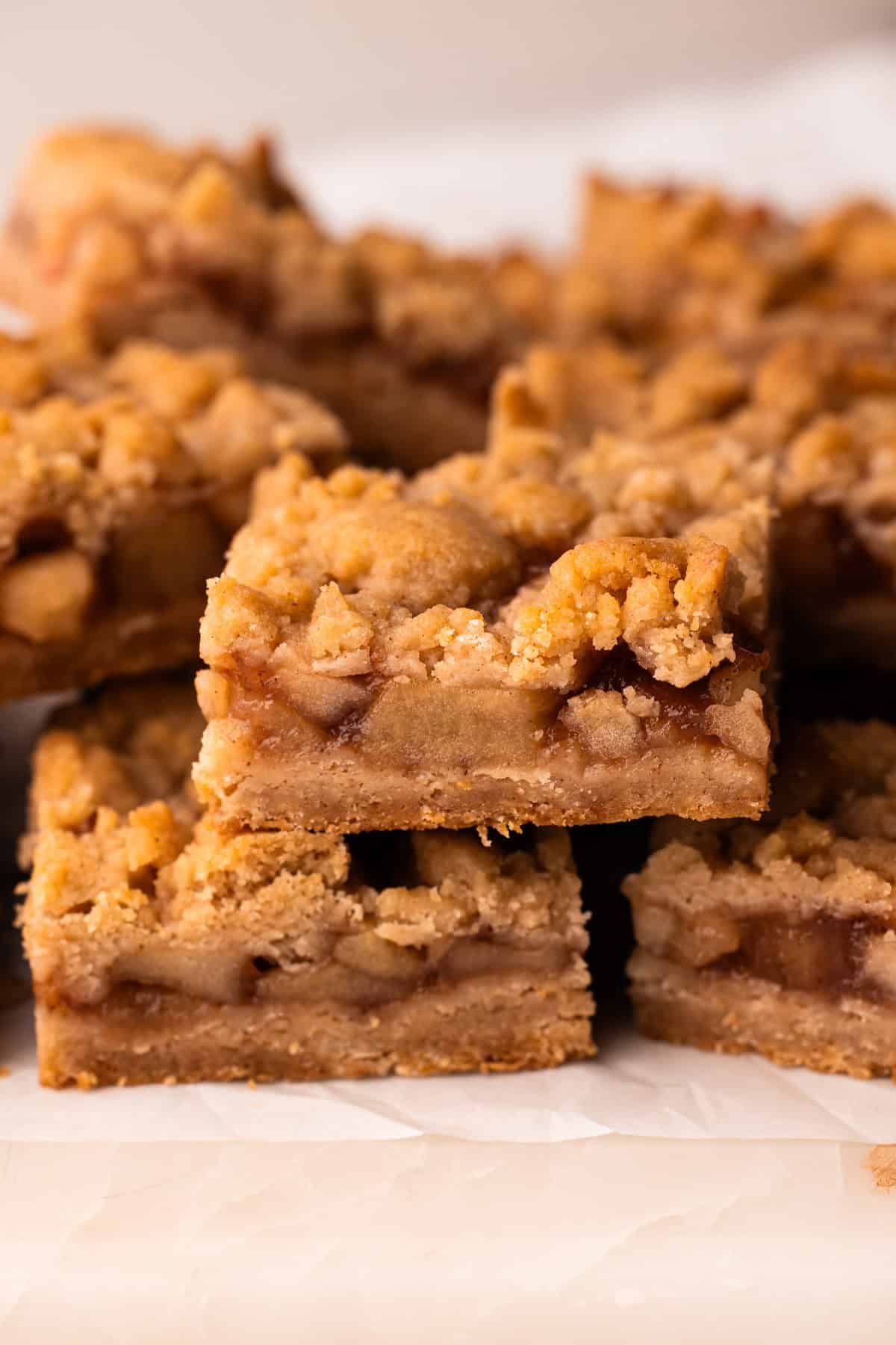 Baked apple pie bars sliced and stacked up.