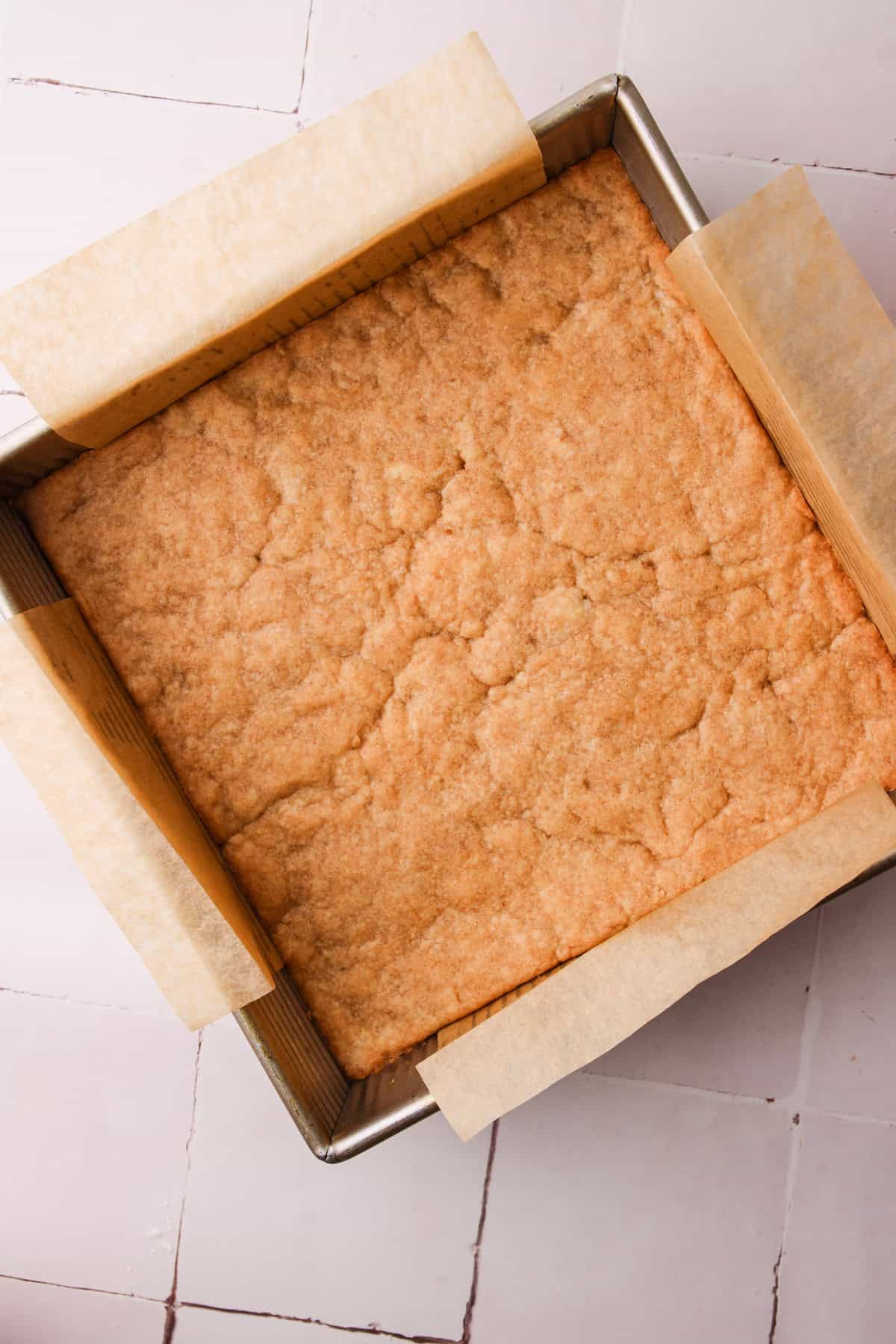 The baked shortbread layer for the apple pie bars.