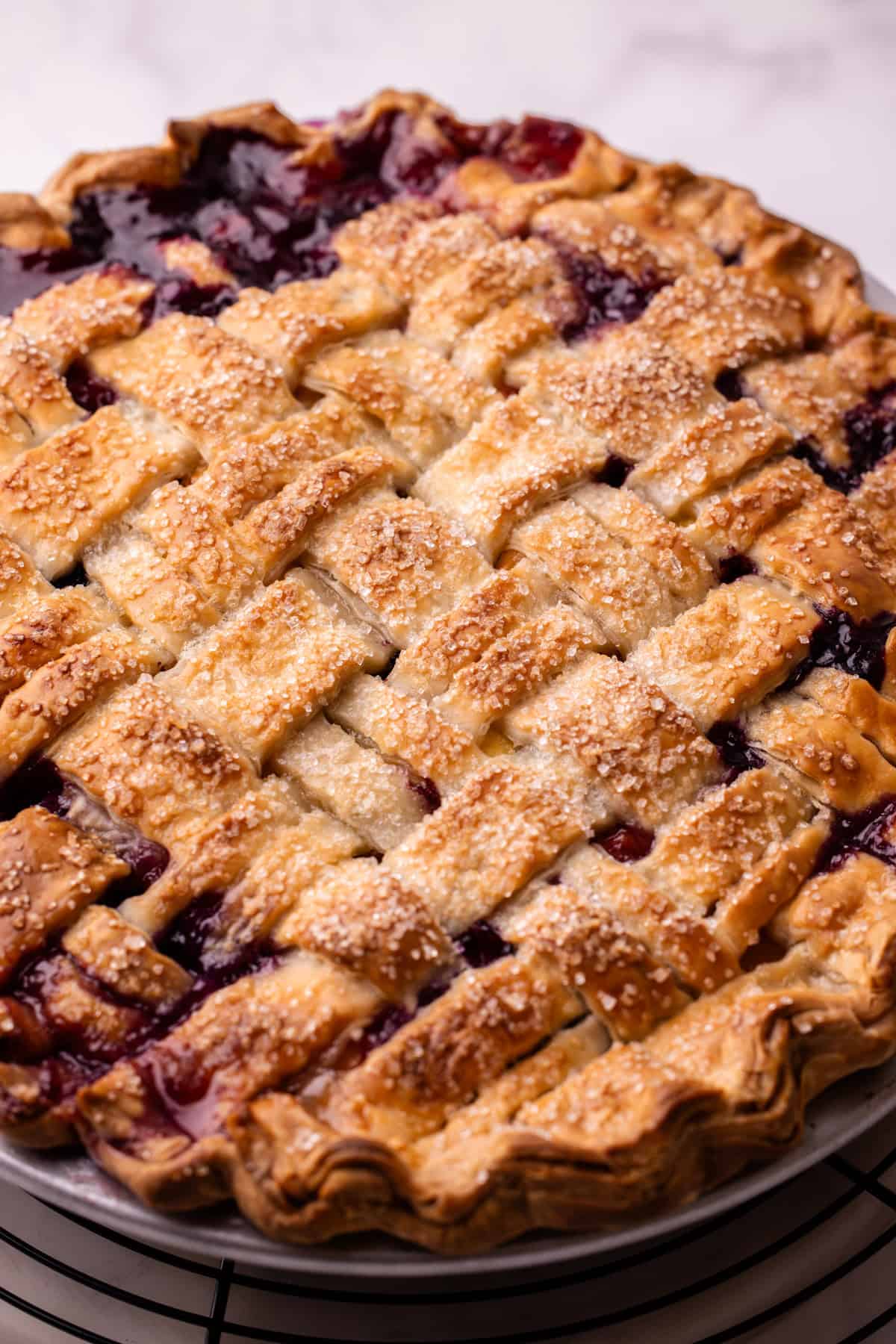 A baked peach and blueberry pie with a beautiful lattice crust.