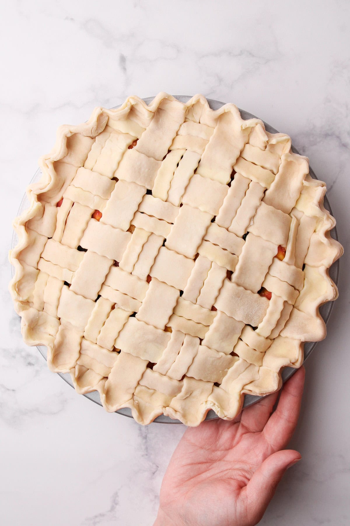 An unbaked peach blueberry pie.