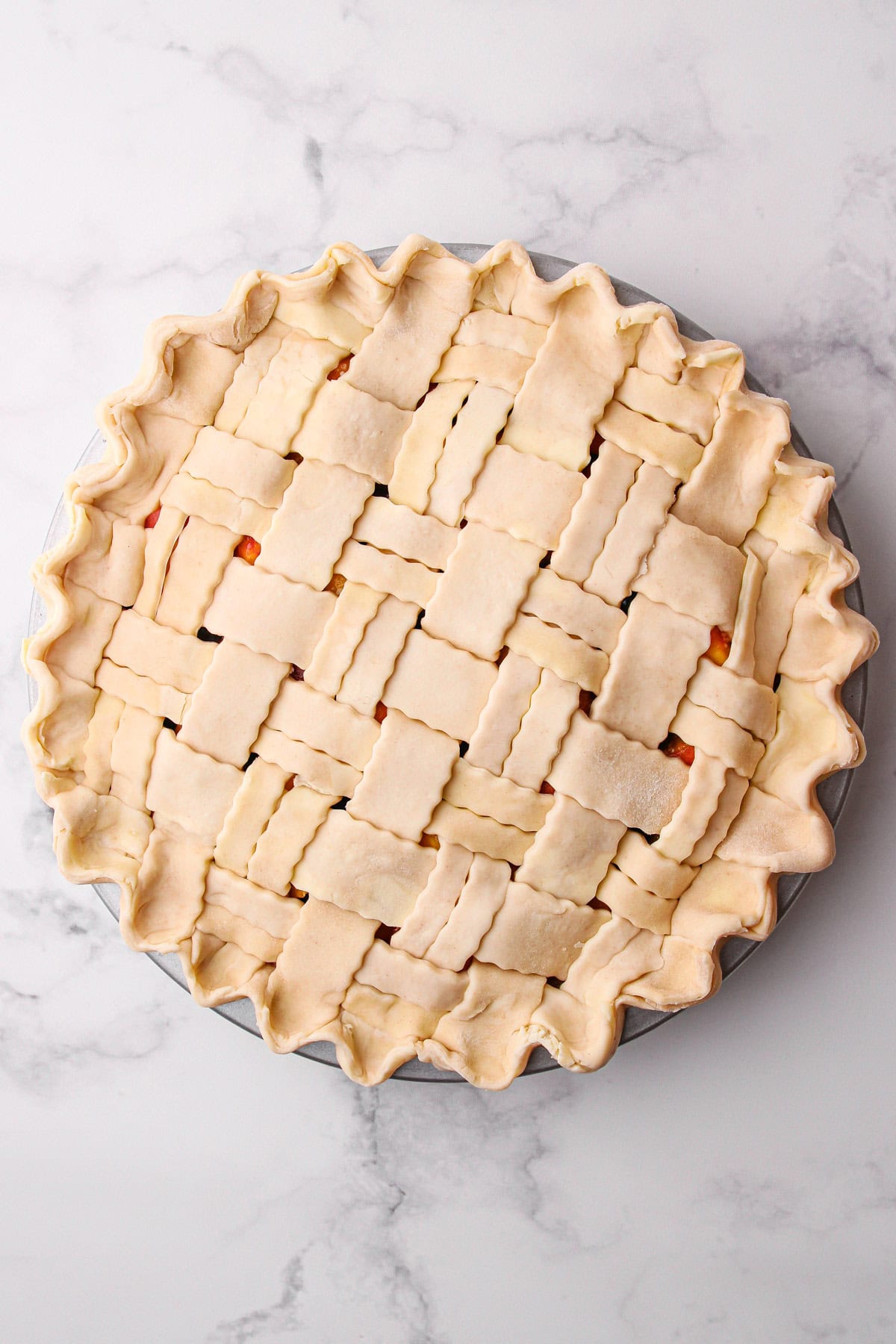 An unbaked peach blueberry pie.