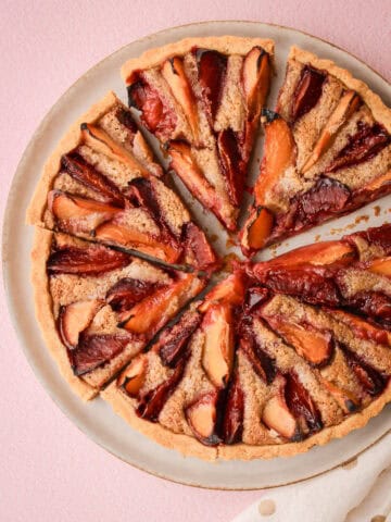 A baked and sliced whole plum pie.