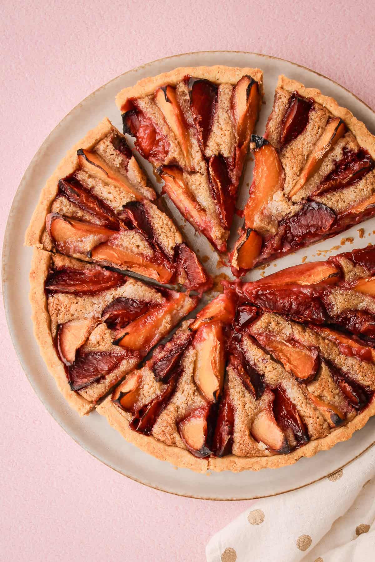 A baked and sliced whole plum pie.
