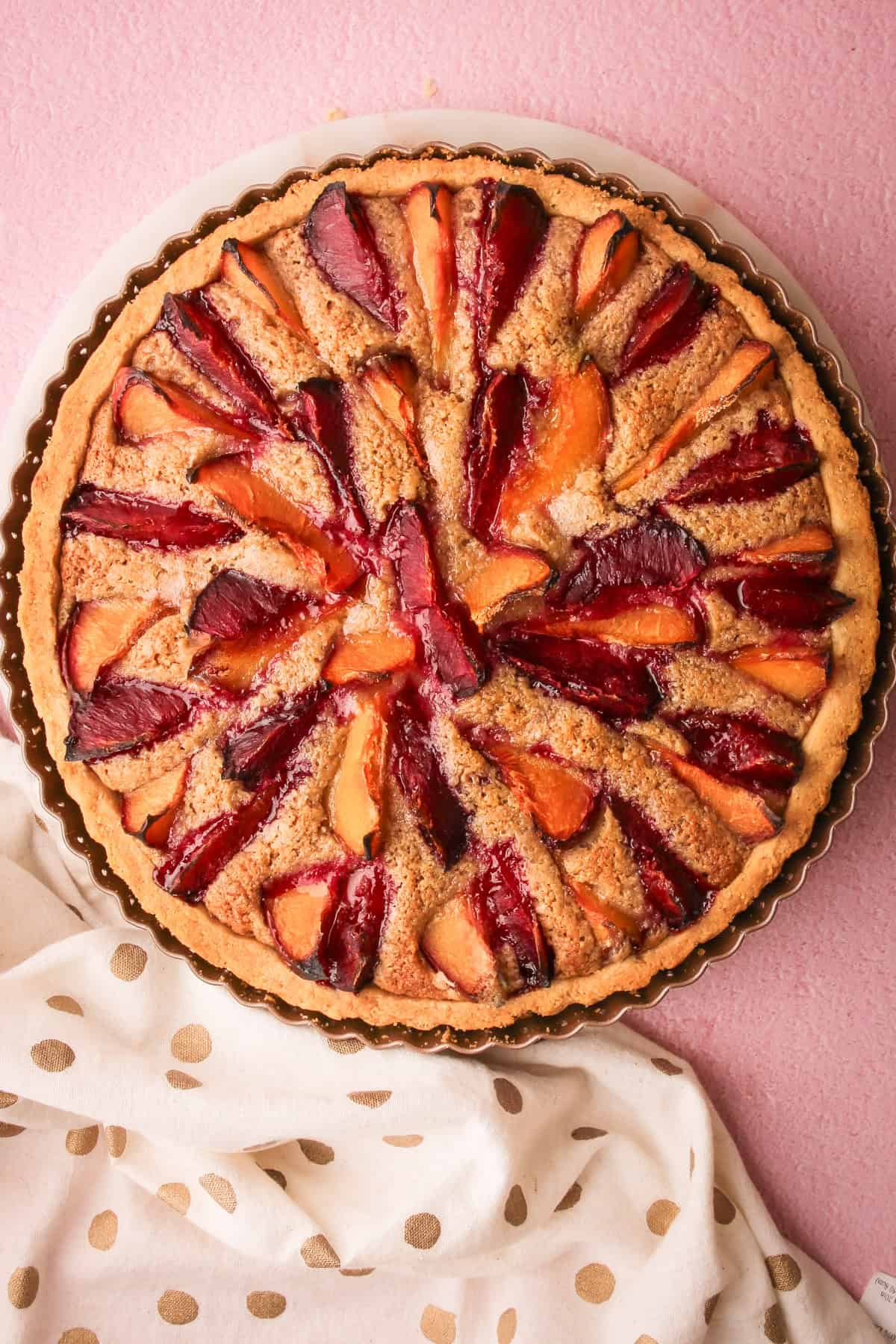 A baked plum pie featuring different colored plums.