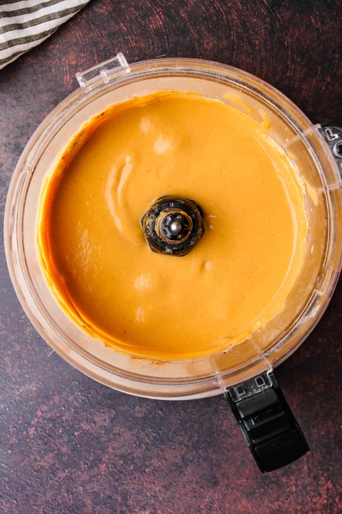 A creamy sweet potato mixture in a food processor.
