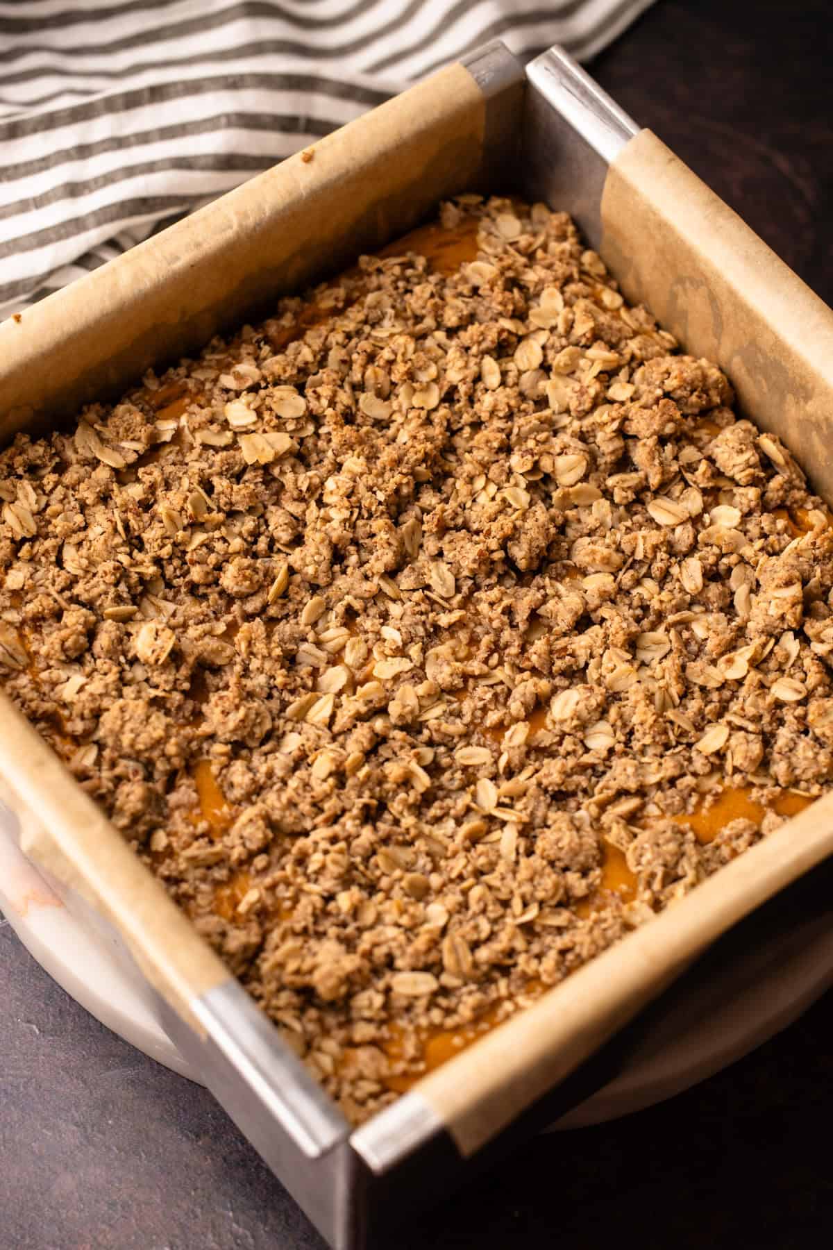 Baked sweet potato pie bars with a pecan crumble topping fresh from the oven.