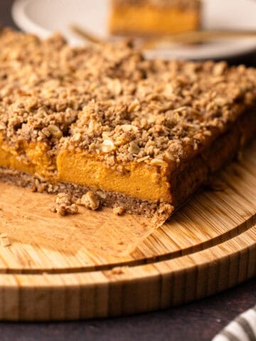 A sliced sweet potato pie bar on a wooden board for serving.