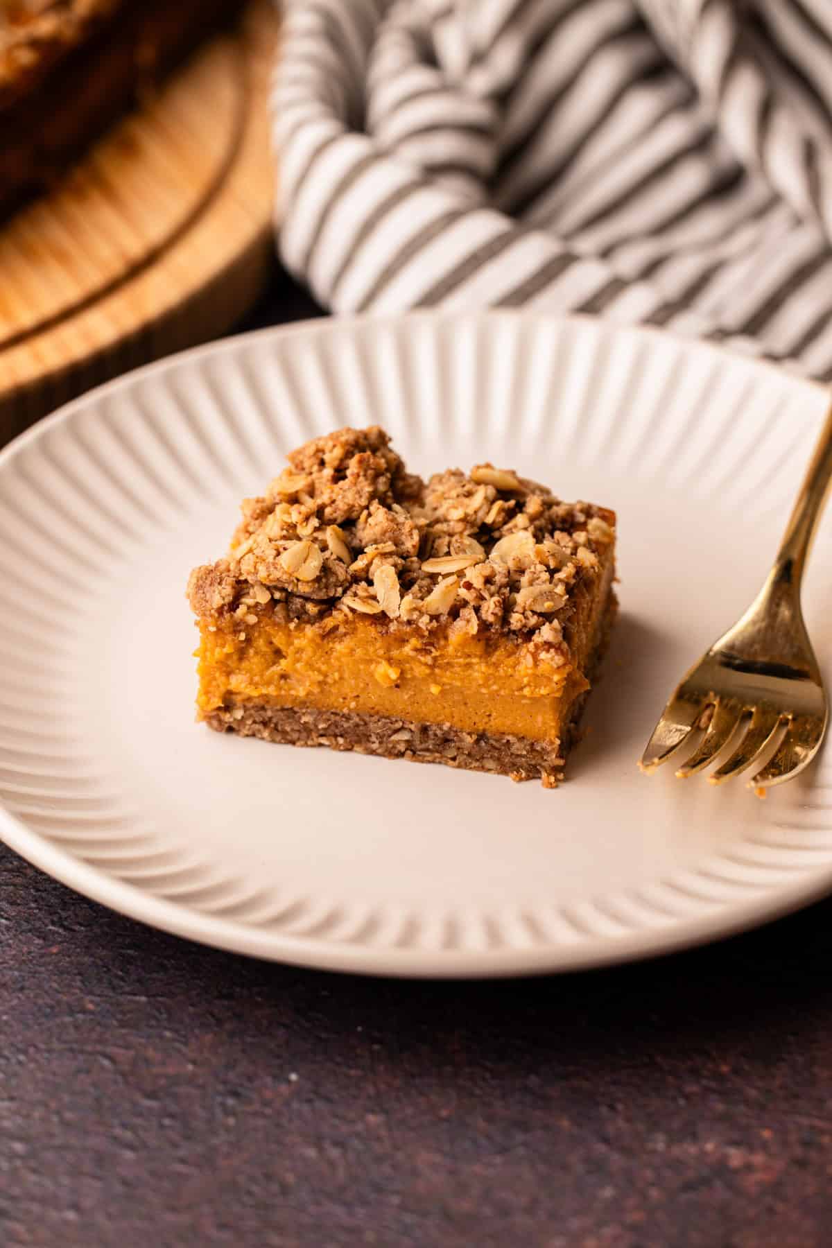 A sweet potato bar with a pecan topping served on a white plate.