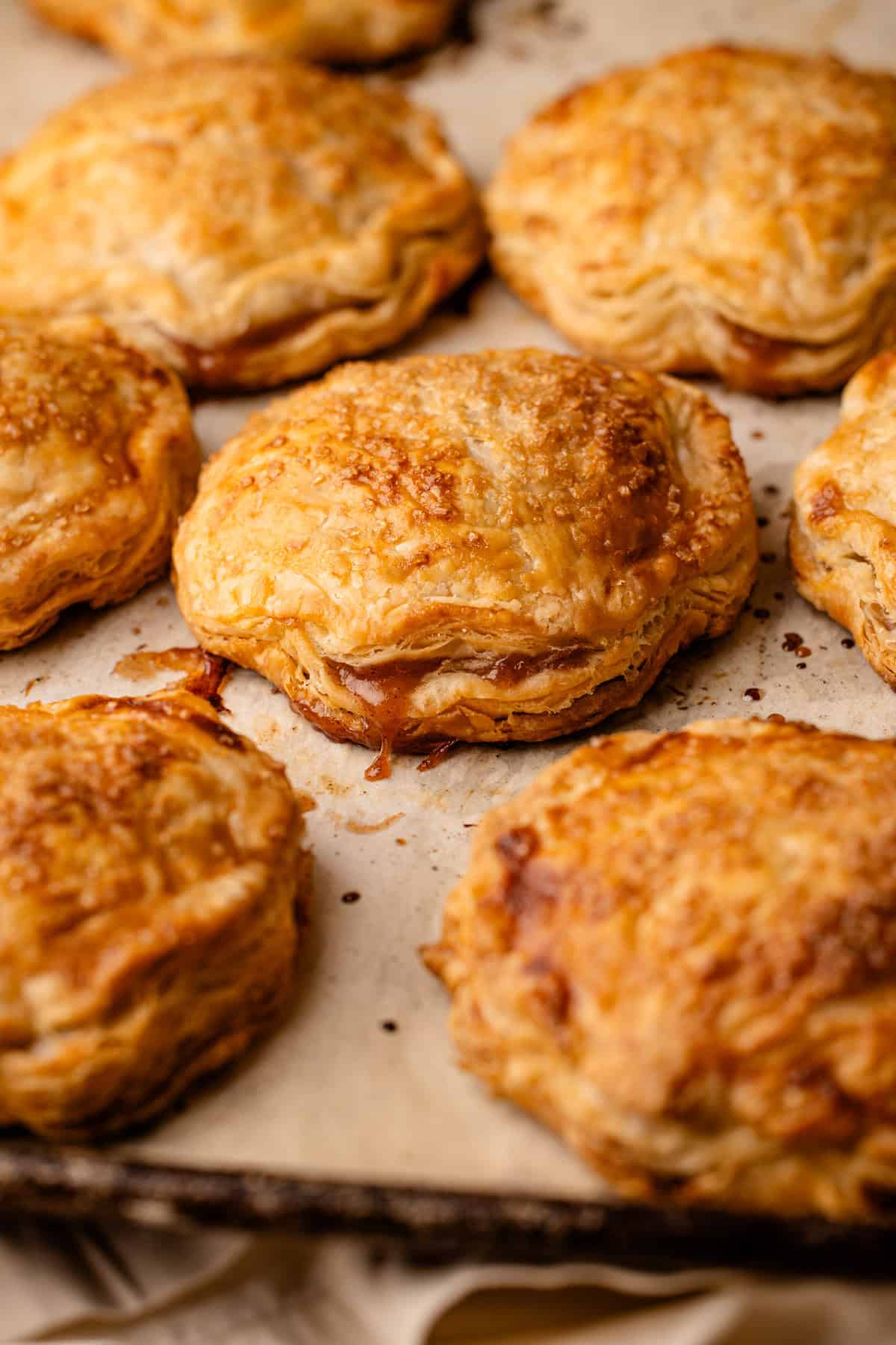 Baked apple hand pies on a sheet pan.