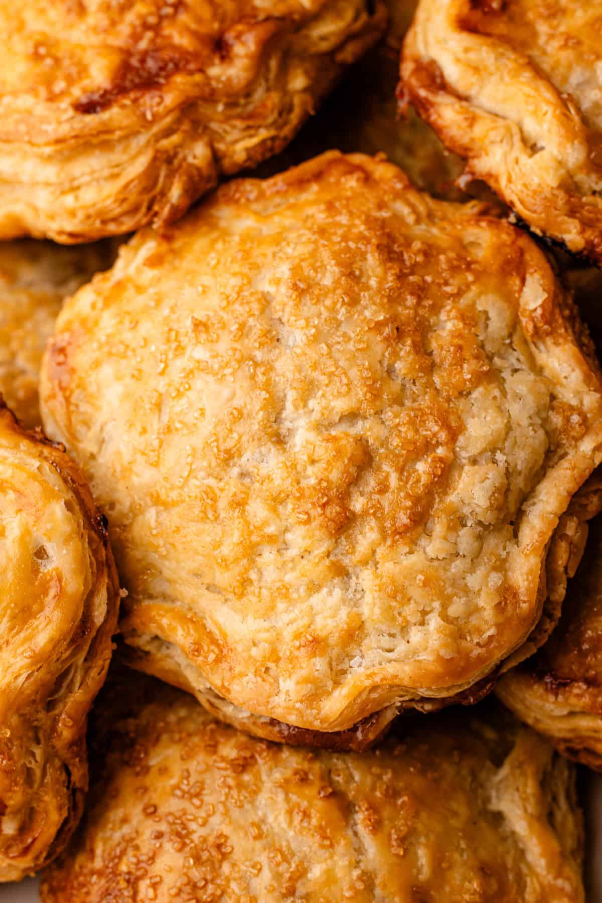 Baked apple hand pies on a sheet pan.