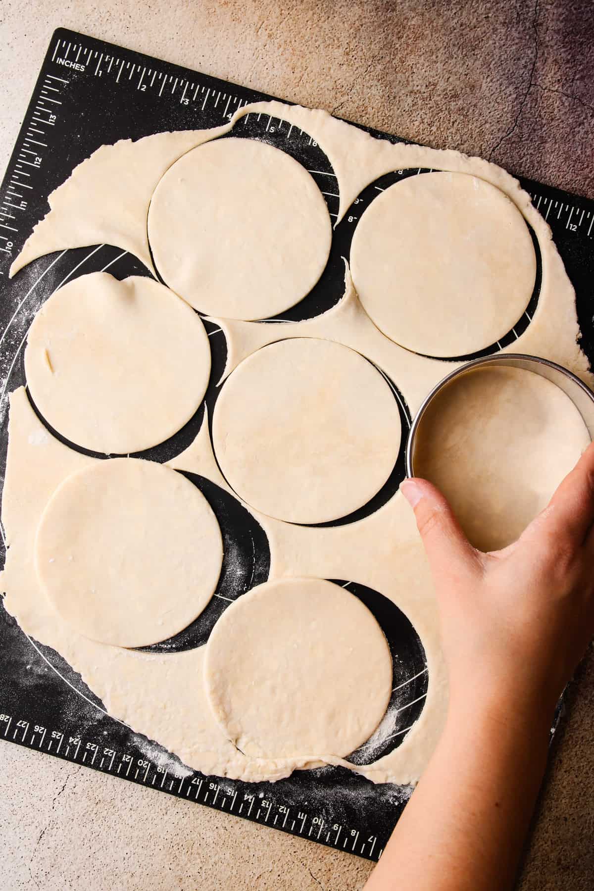 Cutting circles from a cookie cutter for apple hand pies.