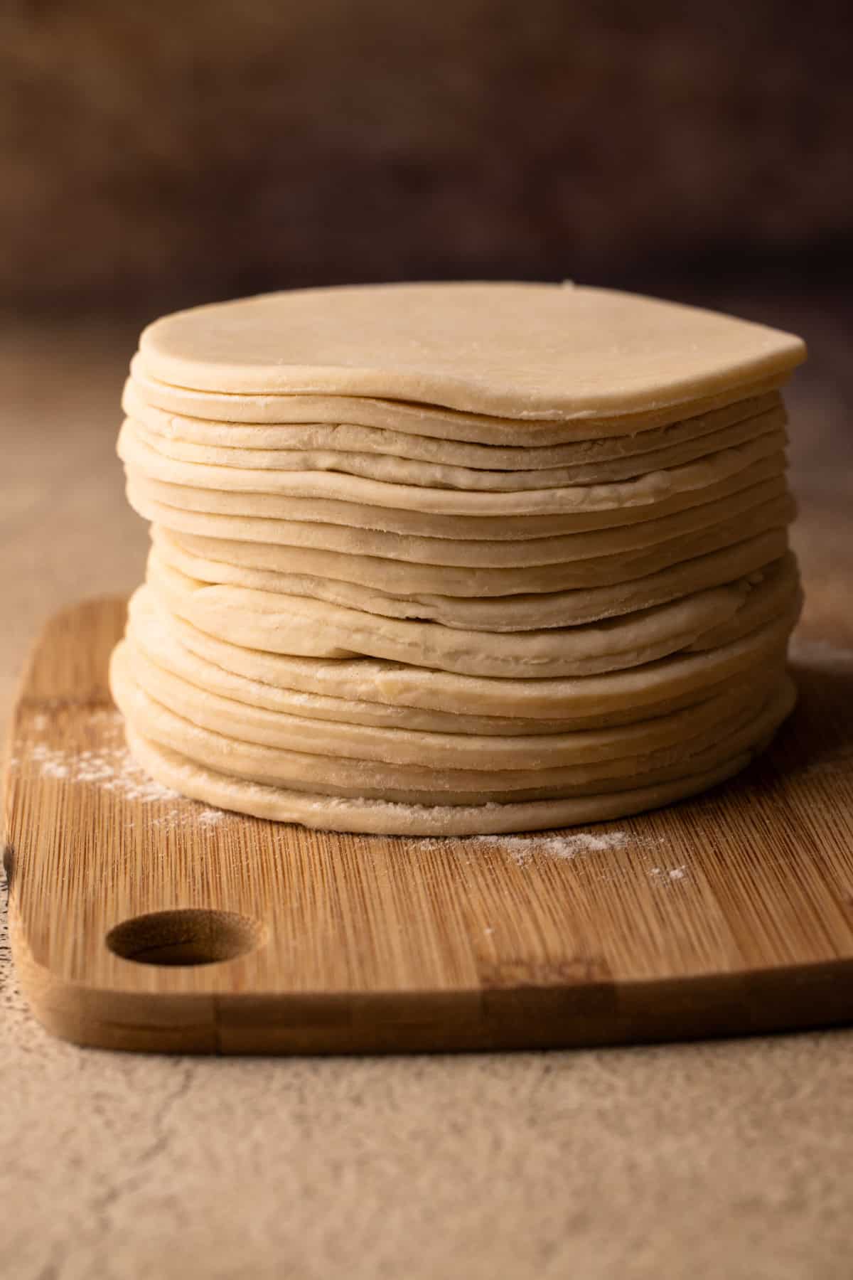 A stack of pie dough circles.