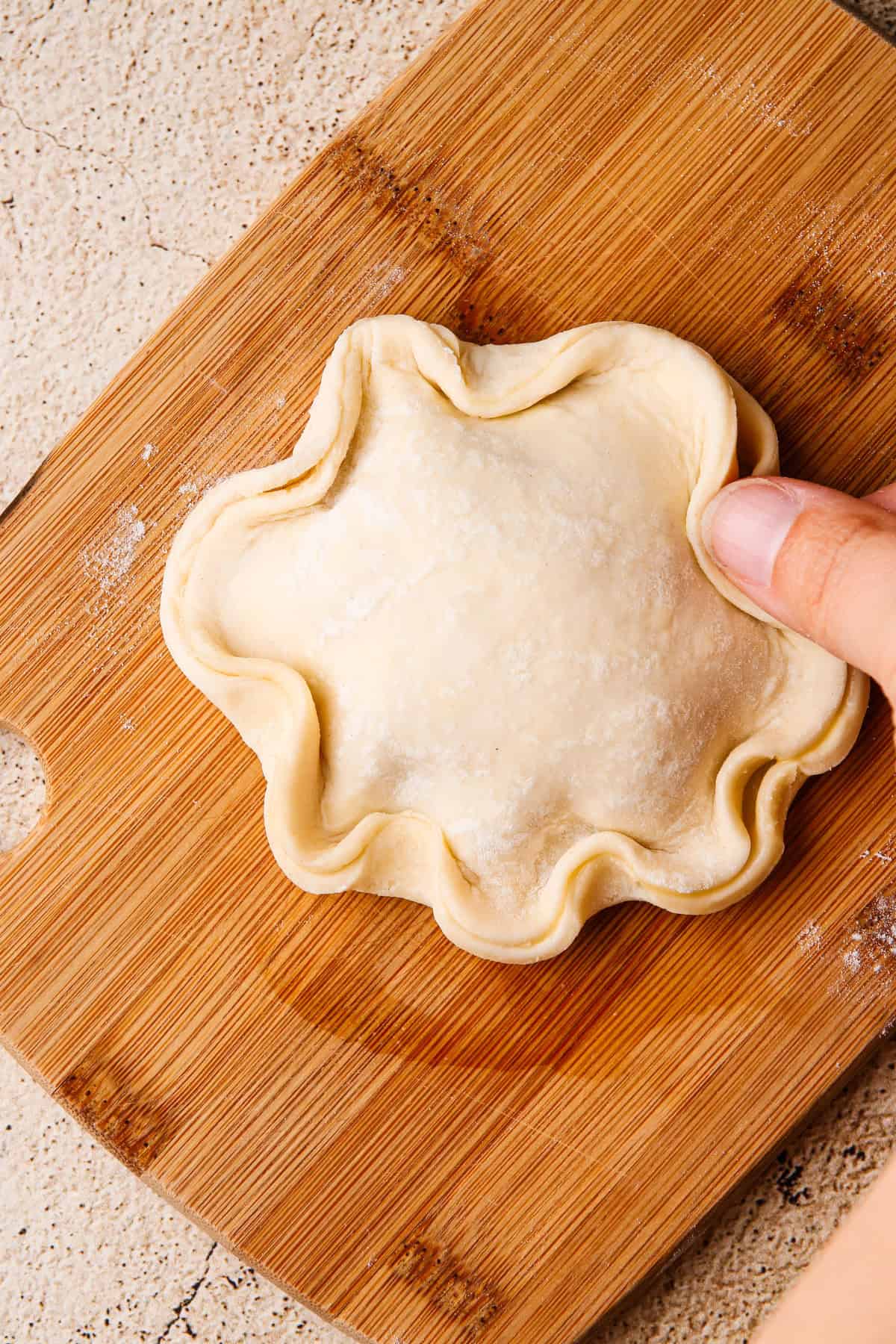 Closing the pastry for the apple hand pie.