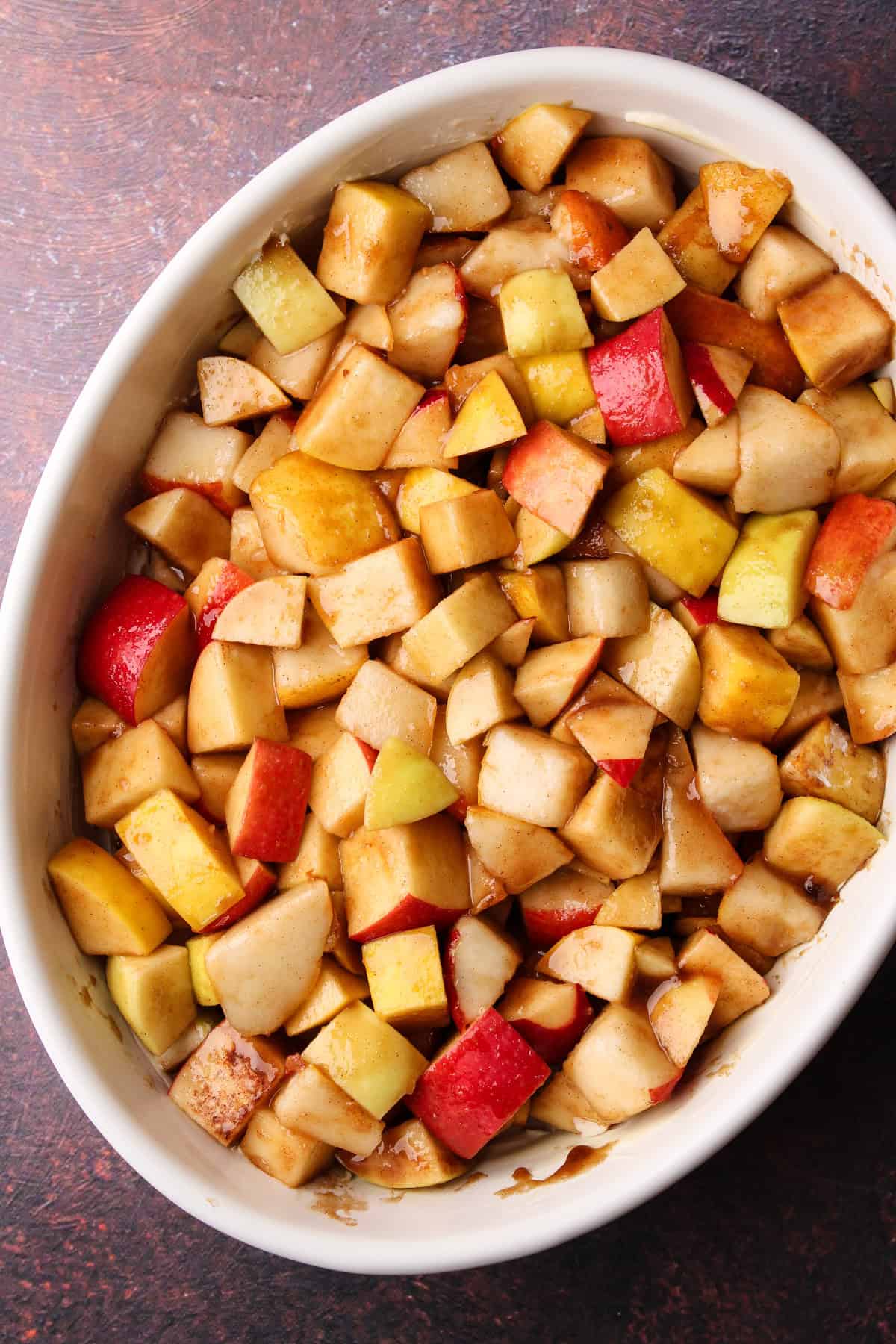 Putting the apple pear filling in the prepared baking dish.
